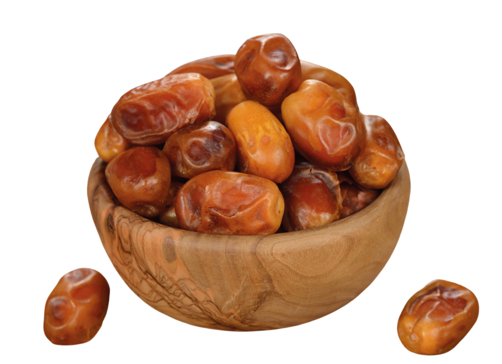 a bowl of dates in a black background